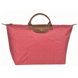 Sac de voyage rose le pliage Longchamp